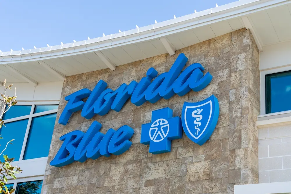 Smiling family reviewing health coverage options with Florida Blue.